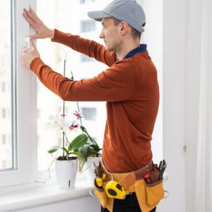 Worker In Protective Gloves, Changing A Double-glazed Window In
