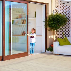 Little girl closing sliding door