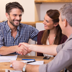 Can you finance hurricane windows - Handshake of a mature manager with a happy young couple at office. Businessmen handshake during meeting signing agreement. Happy man shaking hands with his financial advisor.